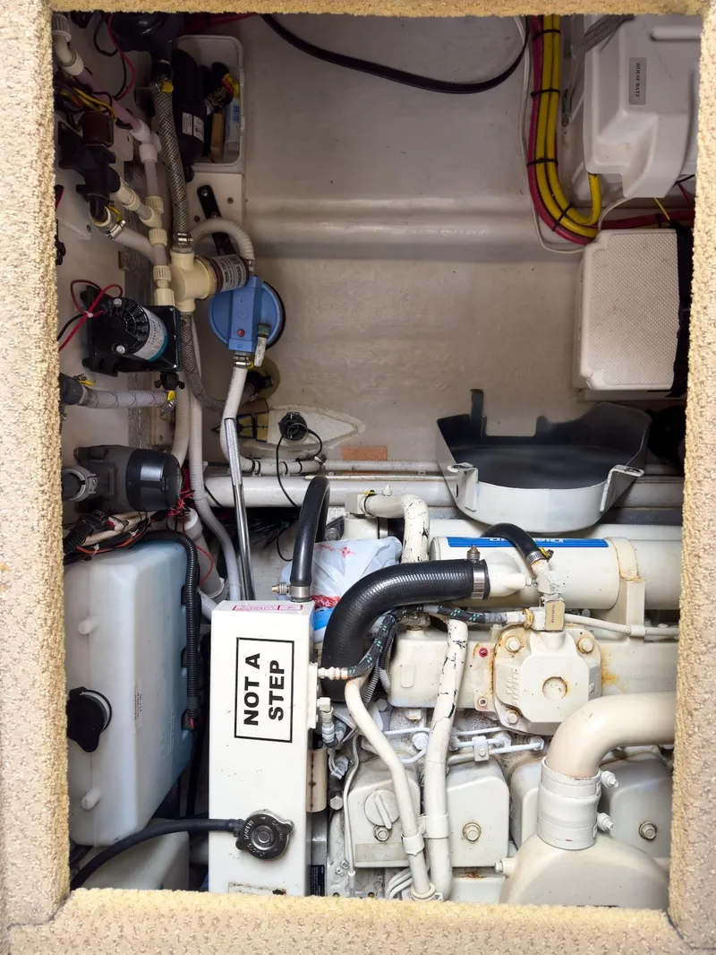 Slide: The Image of Engine compartment of a 2006 Nordic Tug 32' Plus, showcasing mechanical components and wiring. - 20