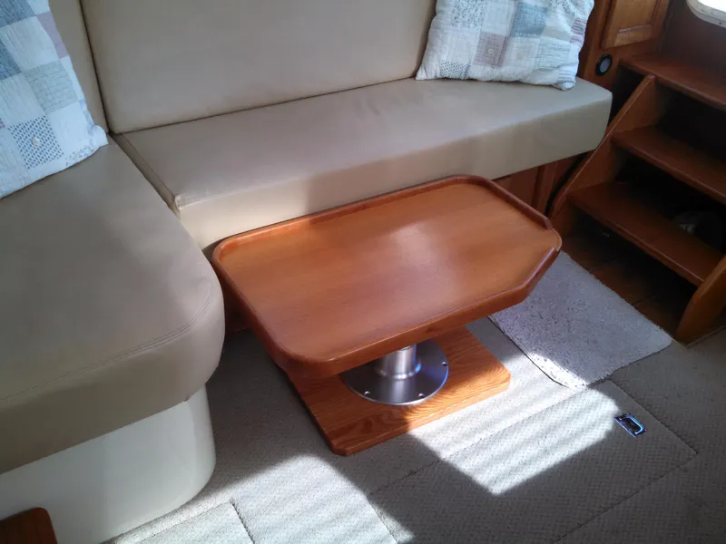 Slide: The Image of Interior of 2006 Nordic Tug 32' Plus with beige seating and wooden table. - 7