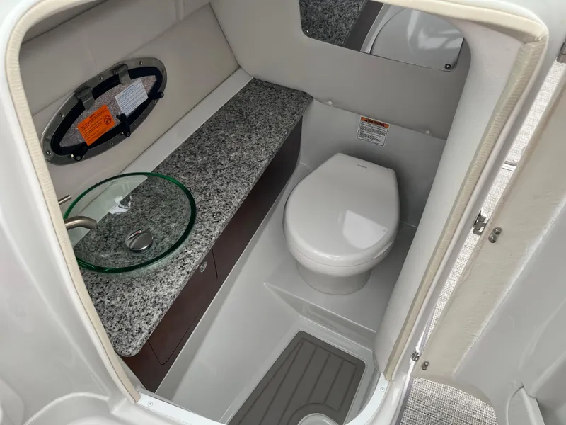 Slide: The Image of 2023 Crownline 260 SS boat bathroom with modern sink and toilet. - 10