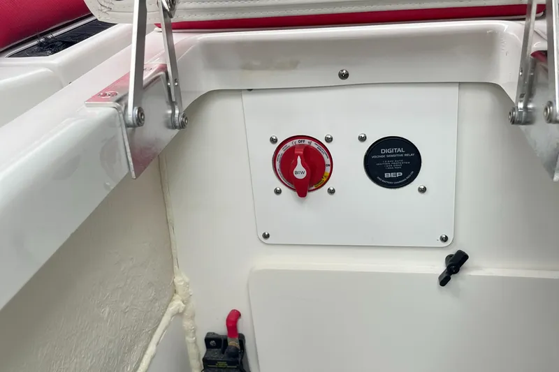 Slide: The Image of 2023 Crownline 260 SS boat control panel with digital switch and red handle. - 12