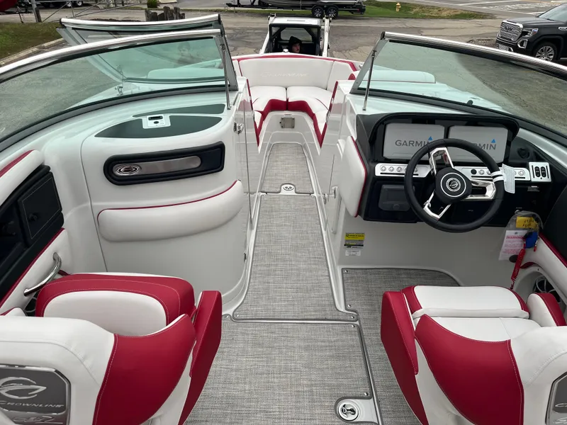 Slide: The Image of 2023 Crownline 260 SS boat interior with red and white seating, modern dashboard, and steering wheel. - 2