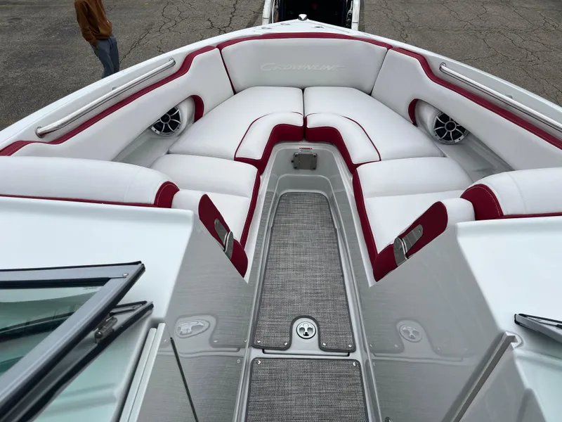 Slide: The Image of 2023 Crownline 260 SS boat interior with white and red seating, gray flooring. - 3