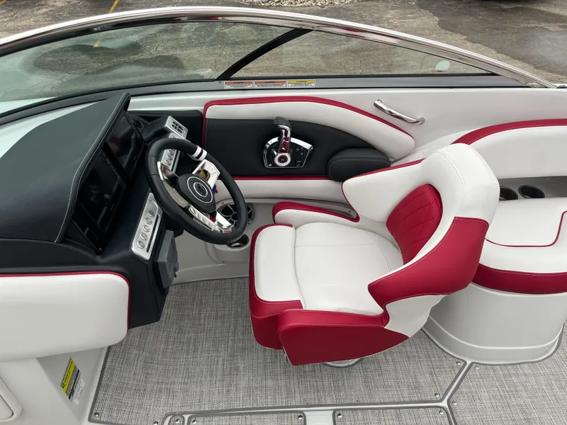 Slide: The Image of 2023 Crownline 260 SS boat interior with red and white seating and modern dashboard. - 6