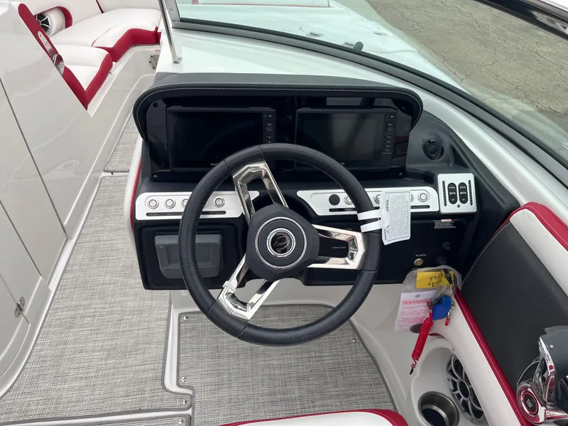 Slide: The Image of 2023 Crownline 260 SS boat dashboard with modern steering and controls. - 7