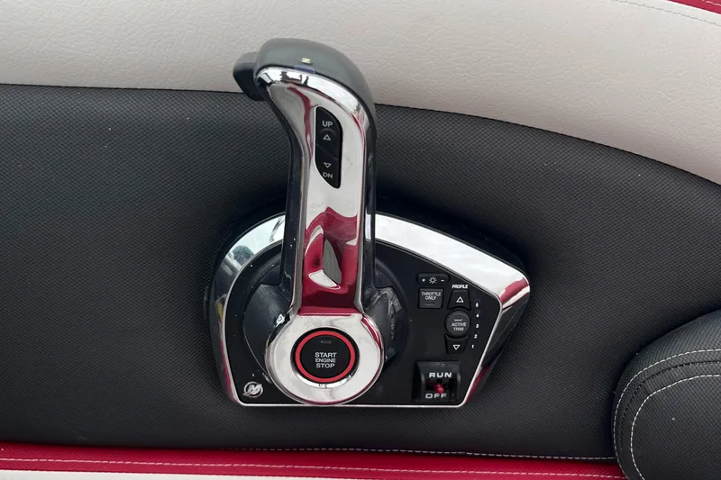 Slide: The Image of Throttle control panel of 2023 Crownline 260 SS boat, featuring start and trim buttons. - 8