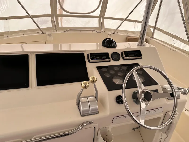 Slide: The Image of Interior of 1990 Ocean Yachts 48 Super Sport with beige seating and helm station. - 13