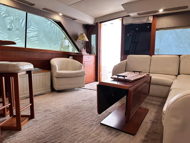 Slide: The Image of Luxurious interior of a 1990 Ocean Yachts 48 Super Sport with elegant seating and wooden accents. - 16