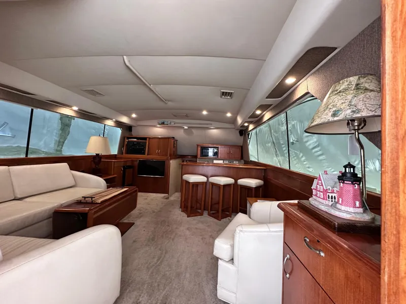 Slide: The Image of Luxurious interior of a 1990 Ocean Yachts 48 Super Sport with elegant seating and wood accents. - 17