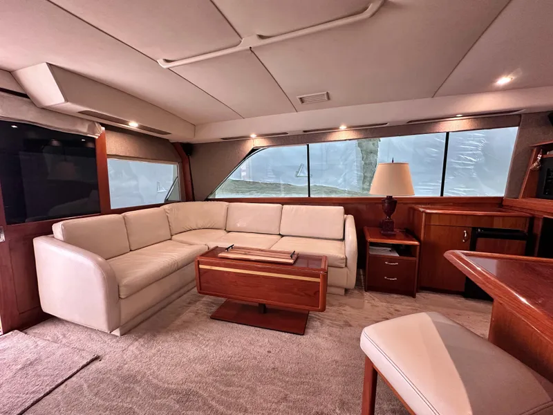 Slide: The Image of Interior of 1990 Ocean Yachts 48 Super Sport with elegant seating and wooden cabinetry. - 18
