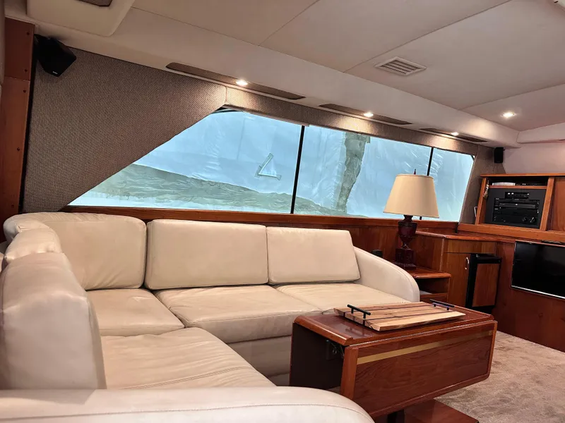 Slide: The Image of Luxurious interior of 1990 Ocean Yachts 48 Super Sport with elegant seating and wooden accents. - 19