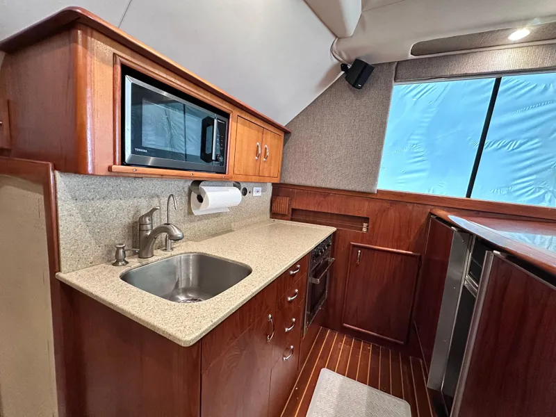 Slide: The Image of Luxurious interior of 1990 Ocean Yachts 48 Super Sport with wood cabinetry and seating. - 21