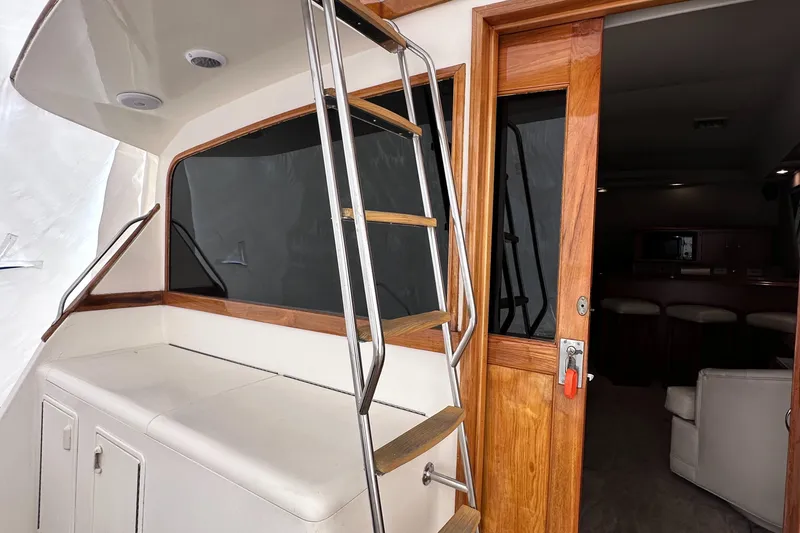 Slide: The Image of 1990 Ocean Yachts 48 Super Sport interior with wooden door and stairs. - 9
