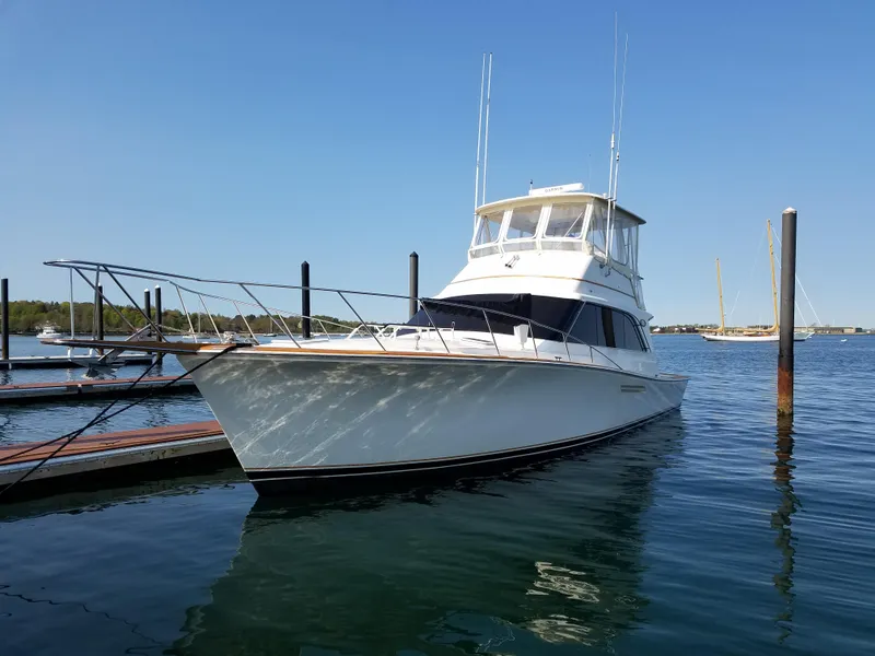 Slide: The Image of 1990 Ocean Yachts 48 Super Sport docked in a marina on a foggy day. - 2