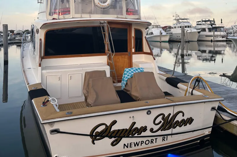 Slide: The Image of 1990 Ocean Yachts 48 Super Sport docked at night with blue lighting. - 6