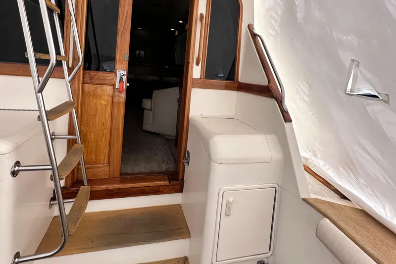 Slide: The Image of 1990 Ocean Yachts 48 Super Sport interior with wooden deck and white upholstery. - 8