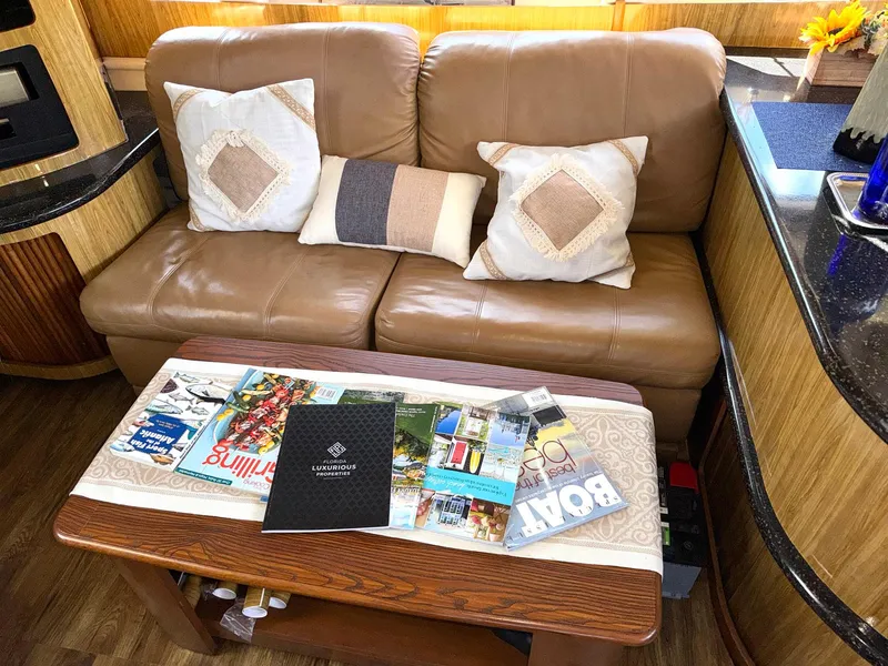 Slide: The Image of Luxurious interior of 2001 Carver 396 Motor Yacht with leather sofa and decorative pillows. - 18