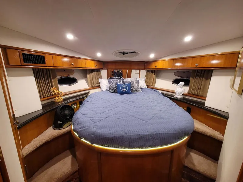 Slide: The Image of Luxurious bedroom interior of 2001 Carver 396 Motor Yacht with cozy bedding and ambient lighting. - 22