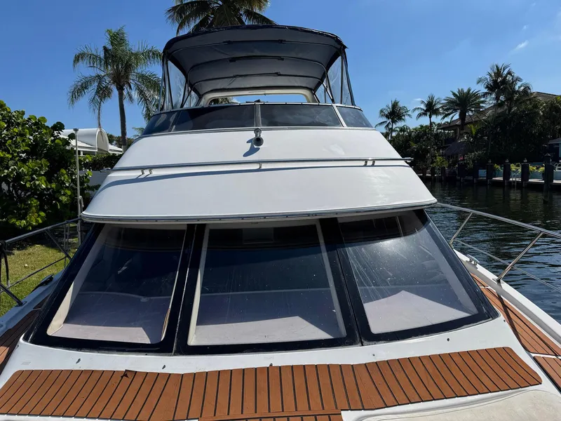 Slide: The Image of 2001 Carver 396 Motor Yacht docked, featuring sleek design and spacious deck. - 3