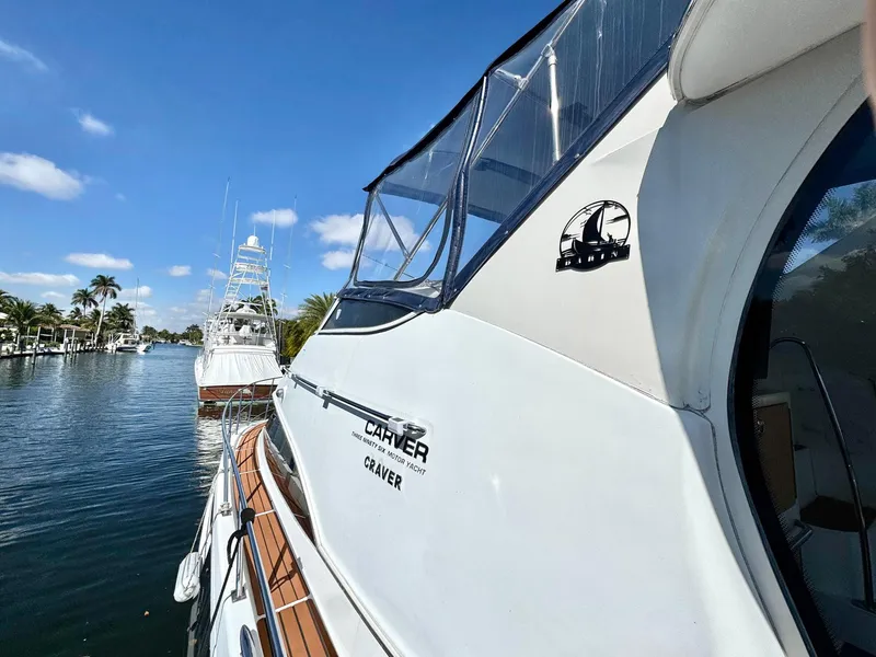 Slide: The Image of 2001 Carver 396 Motor Yacht docked on a sunny day, showcasing sleek design and luxury. - 4
