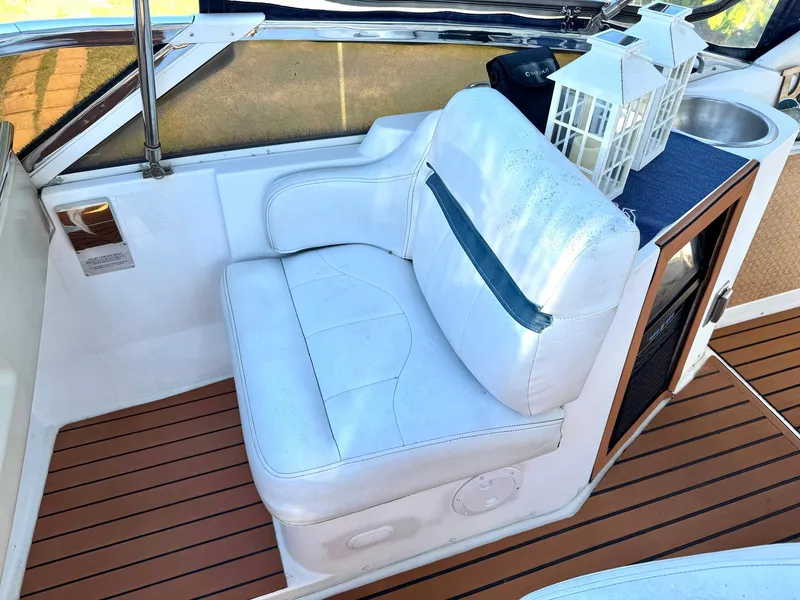 Slide: The Image of White seating area on 2001 Carver 396 Motor Yacht with wooden flooring and decorative lanterns. - 7