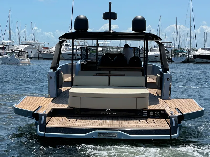 The Image of 2023 Cranchi A46 yacht with spacious deck, docked in a marina. - 0