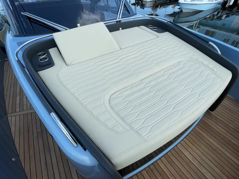 Slide: The Image of 2023 Cranchi A46 yacht with luxurious beige sunbed on deck. - 11