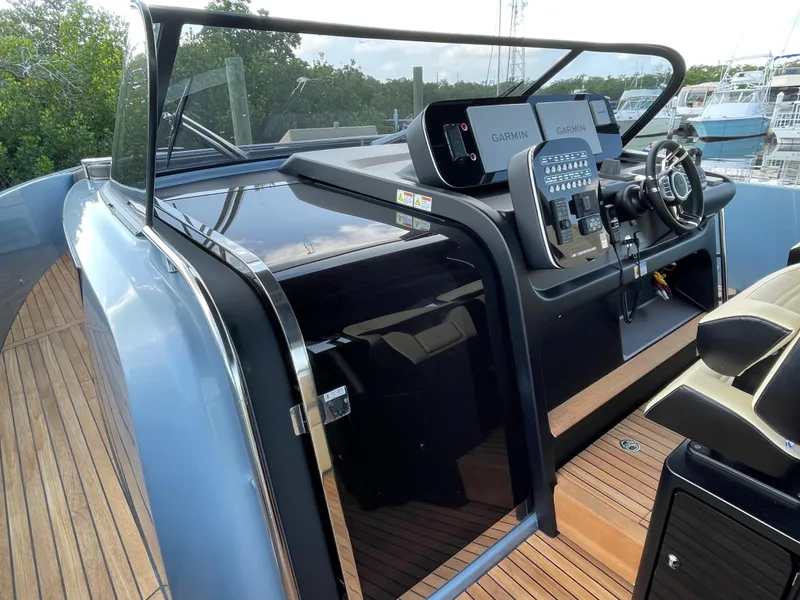 Slide: The Image of 2023 Cranchi A46 yacht helm with modern navigation systems and sleek design. - 12