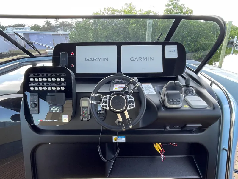 Slide: The Image of 2023 Cranchi A46 helm with Garmin displays and modern navigation controls. - 13