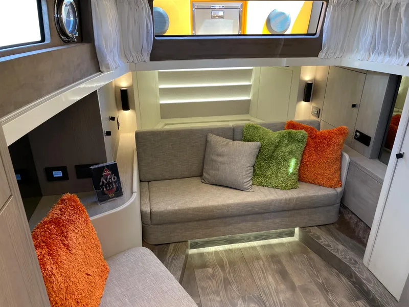 Slide: The Image of Interior of 2023 Cranchi A46 yacht with modern seating and colorful cushions. - 25