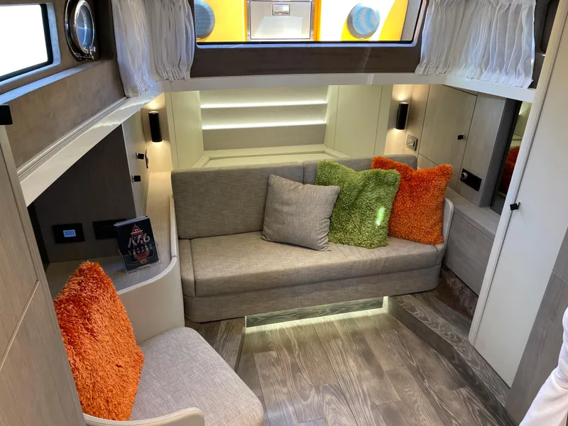 Slide: The Image of 2023 Cranchi A46 yacht interior with modern seating, colorful cushions, and elegant lighting. - 26