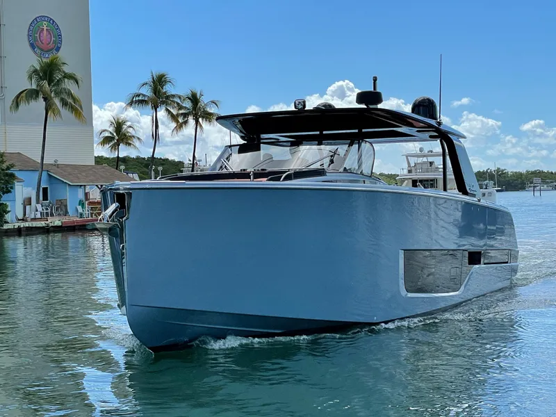 Slide: The Image of 2023 Cranchi A46 yacht cruising in a tropical marina with palm trees. - 3