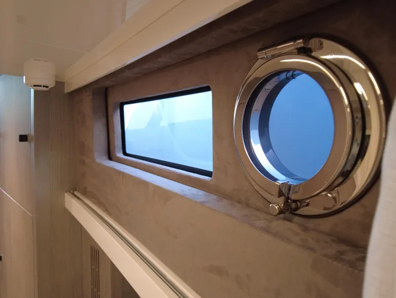 Slide: The Image of Interior view of 2023 Cranchi A46 yacht with porthole and window. - 31
