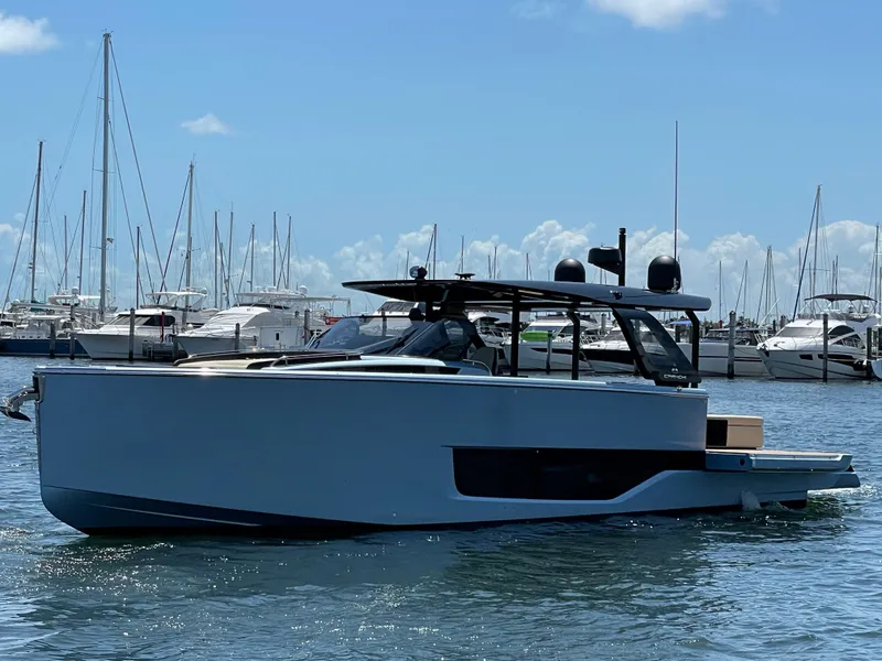 Slide: The Image of 2023 Cranchi A46 yacht in marina, sleek design, clear sky, calm water. - 32