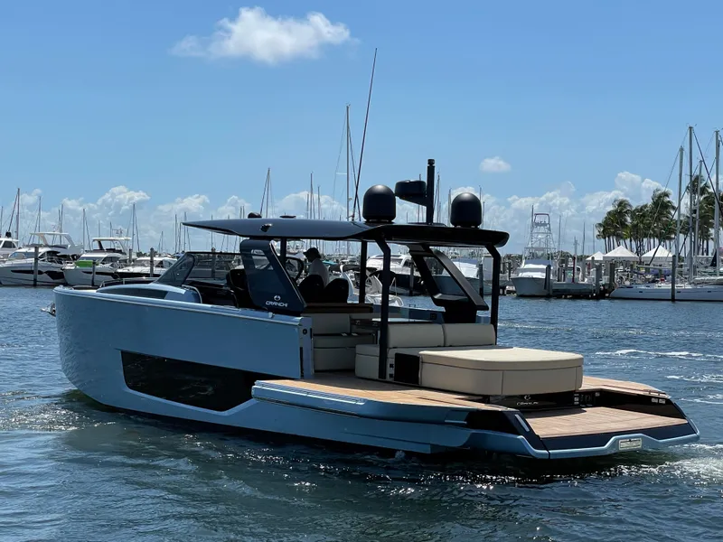 Slide: The Image of 2023 Cranchi A46 yacht cruising in a marina under a clear blue sky. - 33