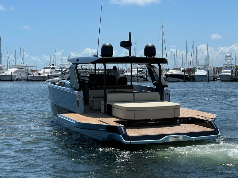 Slide: The Image of 2023 Cranchi A46 yacht in marina, showcasing sleek design and spacious deck. - 36
