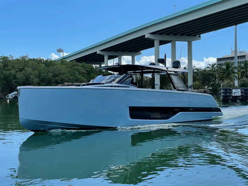 Slide: The Image of 2023 Cranchi A46 yacht cruising under a bridge on a sunny day. - 4