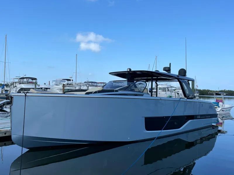 Slide: The Image of 2023 Cranchi A46 yacht docked in a marina under a clear blue sky. - 6