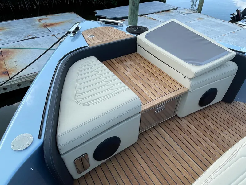 Slide: The Image of 2023 Cranchi A46 boat interior with teak flooring and cushioned seating. - 9