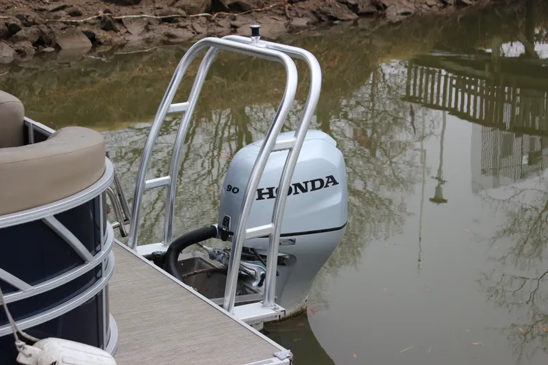 Slide: The Image of 2023 Sylvan Mirage 820 LZ pontoon with Honda outboard motor in water. - 13