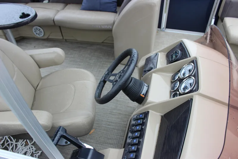 Slide: The Image of 2023 Sylvan Mirage 820 LZ boat interior with steering wheel and dashboard controls. - 18