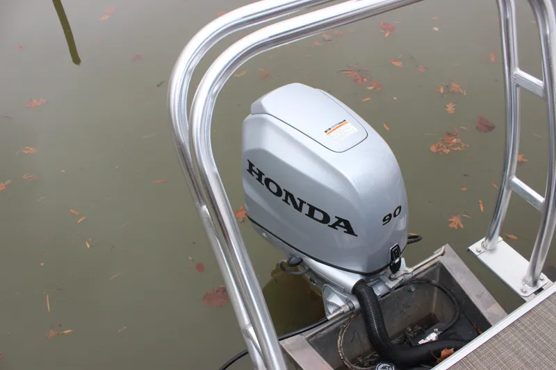 Slide: The Image of 2023 Sylvan Mirage 820 LZ with Honda 90 outboard motor on calm water. - 19