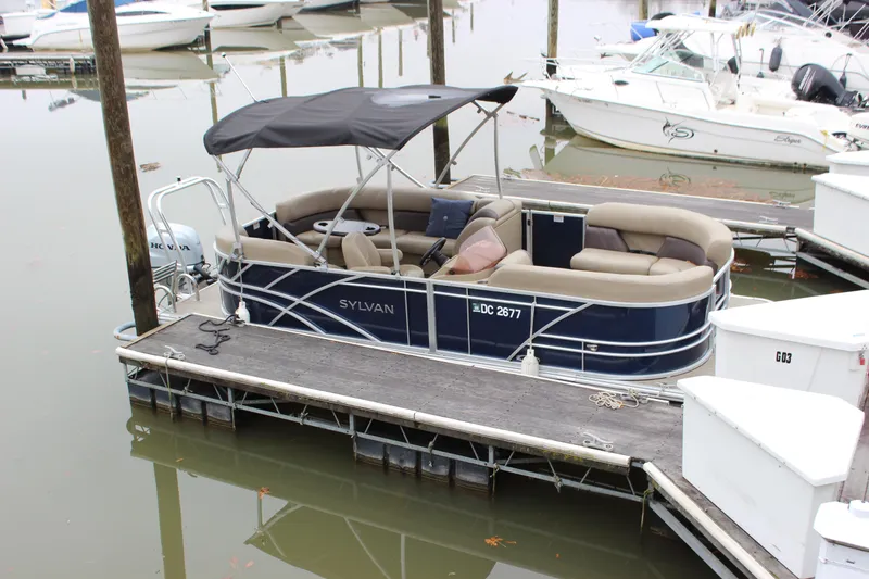 Slide: The Image of 2023 Sylvan Mirage 820 LZ pontoon boat docked with canopy and seating. - 2