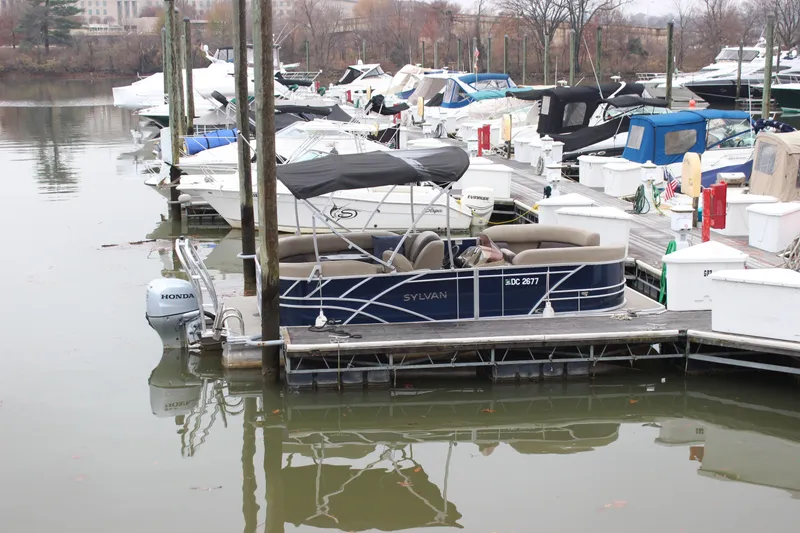 Slide: The Image of 2023 Sylvan Mirage 820 LZ pontoon boat docked in a marina. - 22