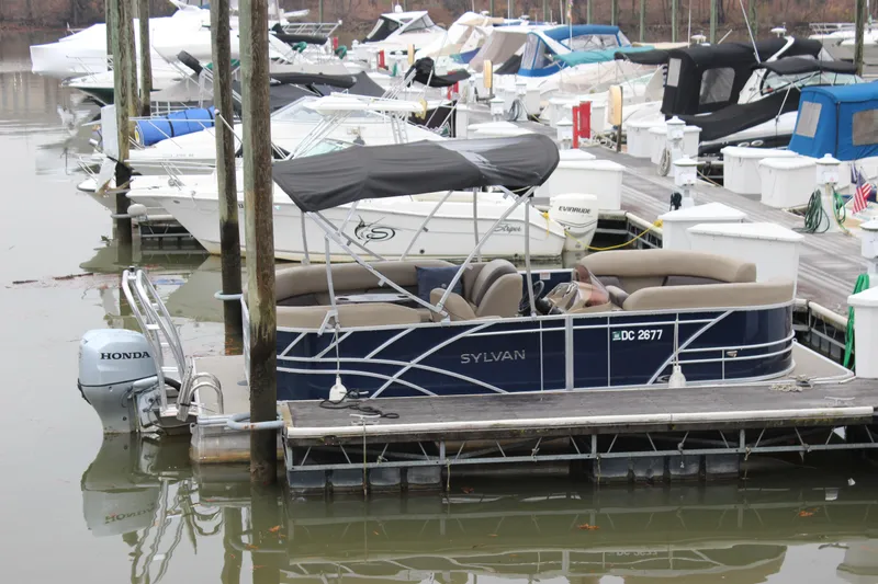 Slide: The Image of 2023 Sylvan Mirage 820 LZ pontoon boat docked in a marina. - 23