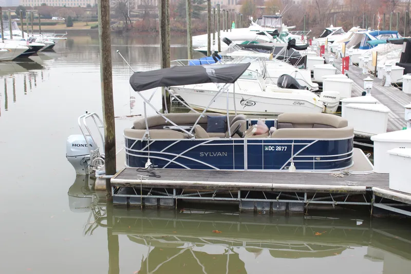 Slide: The Image of 2023 Sylvan Mirage 820 LZ pontoon boat docked in a marina. - 24