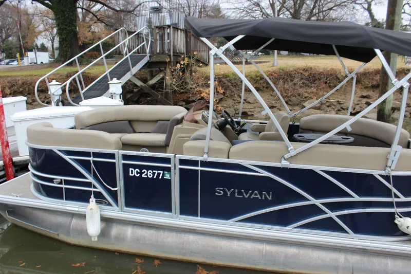 Slide: The Image of 2023 Sylvan Mirage 820 LZ pontoon boat docked with canopy and seating. - 4
