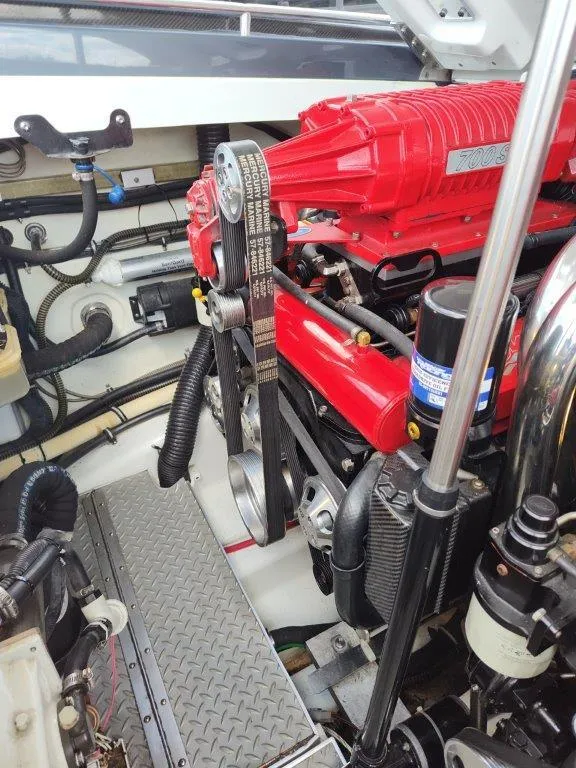 Slide: The Image of Engine compartment of a 2015 Formula 382 FASTech boat, featuring a red engine and components. - 14