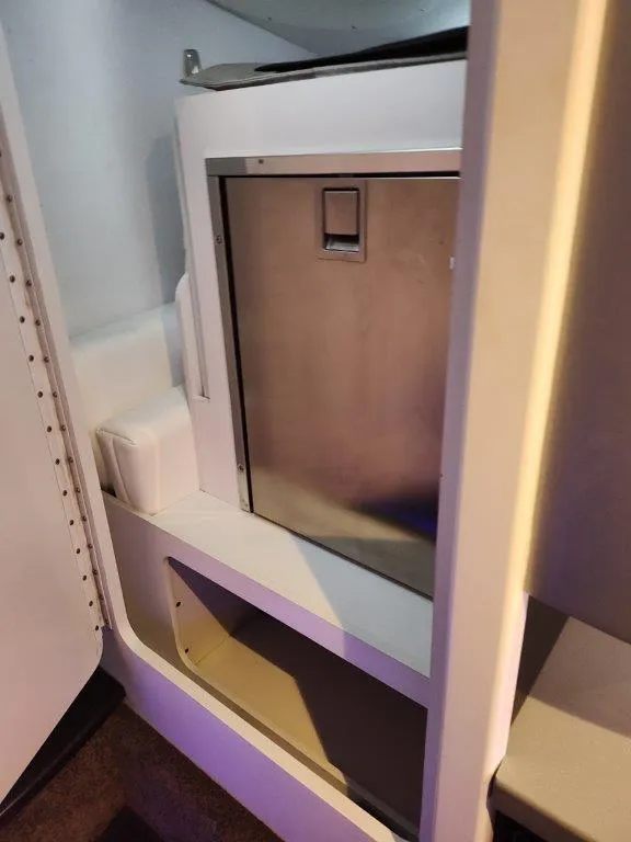 Slide: The Image of Interior of a 2015 Formula 382 FASTech boat, featuring a compact stainless steel cabinet. - 21