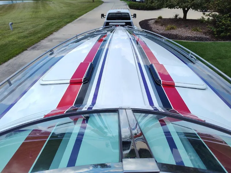 Slide: The Image of 2015 Formula 382 FASTech boat with colorful stripes on a trailer. - 22