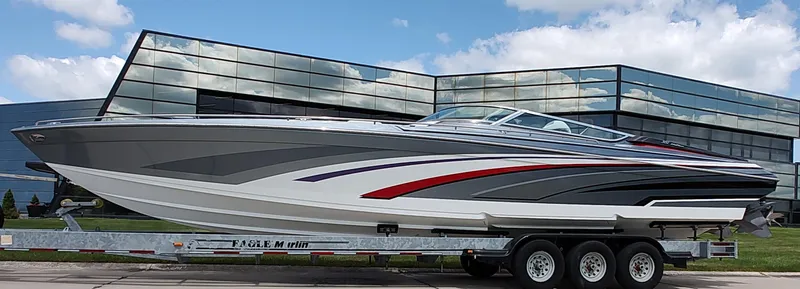 Slide: The Image of 2015 Formula 382 FASTech boat on trailer, sleek design, parked near modern glass building. - 27